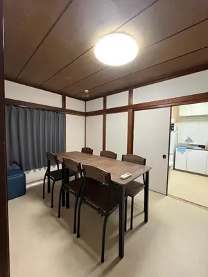 a dining room with a wooden table and chairs at Abeno house at Koenji in Tokyo