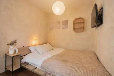 a bedroom with a large bed and a television at \u30ec\u30b8\u30c7\u30f3\u30b9\u30d1\u30fc\u30af\u6d45\u8349 in Tokyo