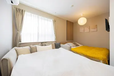 a living room with a bed and a window at \u30ec\u30b8\u30c7\u30f3\u30b9\u30d1\u30fc\u30af\u6d45\u8349 in Tokyo