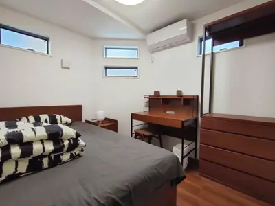 a bedroom with a bed and a desk and a desk at SunRiseStay Yahiro House\u516b\u5e83\u4e00\u6238\u5efa\u3066 in Tokyo