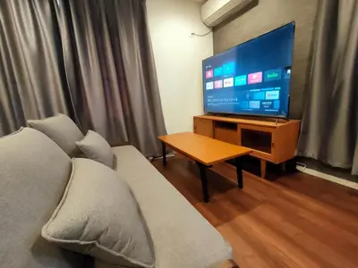 a living room with a couch and a flat screen tv at SunRiseStay Yahiro House\u516b\u5e83\u4e00\u6238\u5efa\u3066 in Tokyo