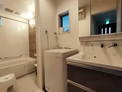a white bathroom with a sink and a toilet and a mirror at SunRiseStay Yahiro House\u516b\u5e83\u4e00\u6238\u5efa\u3066 in Tokyo