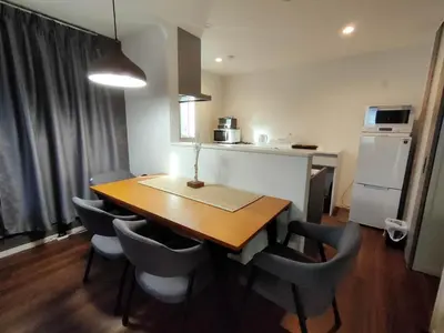 a kitchen with a dining room table and chairs at SunRiseStay Yahiro House\u516b\u5e83\u4e00\u6238\u5efa\u3066 in Tokyo