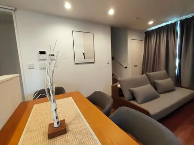 a living room with a table and a couch at SunRiseStay Yahiro House\u516b\u5e83\u4e00\u6238\u5efa\u3066 in Tokyo