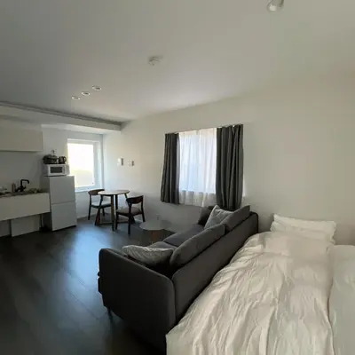 a living room with a couch and a table at KICHI 2F 10min to Shinjuku in Tokyo