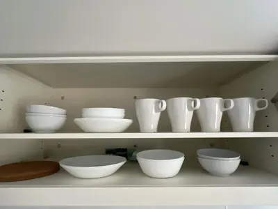 a shelf with white bowls and vases on it at KICHI 2F 10min to Shinjuku in Tokyo
