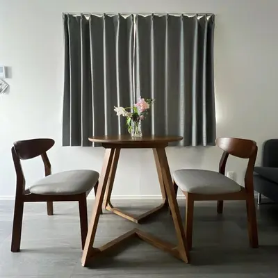 a table with two chairs and a vase with flowers on it at KICHI 2F 10min to Shinjuku in Tokyo