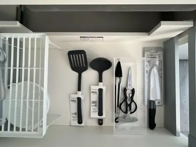 a shelf with kitchen utensils in a cabinet at KICHI 2F 10min to Shinjuku in Tokyo