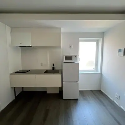 a white kitchen with a sink and a microwave at KICHI 2F 10min to Shinjuku in Tokyo