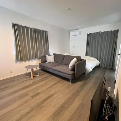 a living room with a couch and a bed at KICHI 2F 10min to Shinjuku in Tokyo