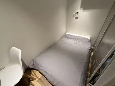 a small bed in a corner of a room at Sunny Haven in Tokyo in Tokyo