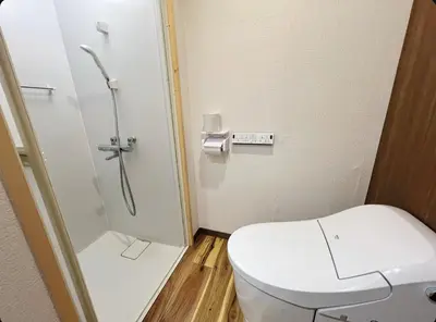 a small bathroom with a toilet and a shower at Sunny Haven in Tokyo in Tokyo