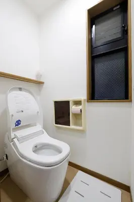 a white toilet in a bathroom with a window at Tokyo My Home 1 in Tokyo