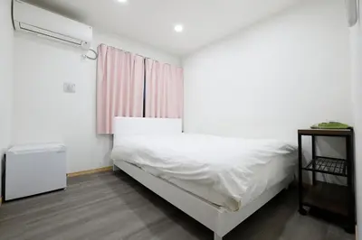 a bedroom with a white bed and a window at Tokyo My Home 202 in Tokyo