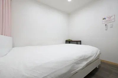 a white bed in a white room with aigiligiligiligiligil at Tokyo My Home 202 in Tokyo