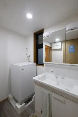 a bathroom with a sink and a toilet and a mirror at Tokyo My Home 202 in Tokyo