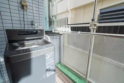 a bird cage with a food machine in it at Crest House in Tokyo