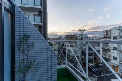 a view of a city from the balcony of a building at Crest House in Tokyo