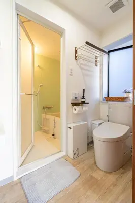 a bathroom with a toilet and a shower at Crest House in Tokyo