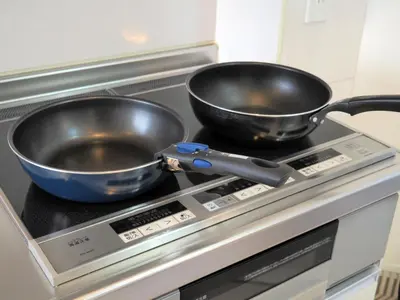 two pans sitting on top of a stove at Yamatsu Tokyo House in Tokyo
