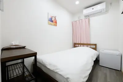a small bedroom with a bed and a desk at Tokyo My Home 2 in Tokyo