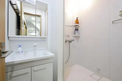 a white bathroom with a sink and a shower at 3 min from Shin-Okubo l Private Single Room 3 in Tokyo