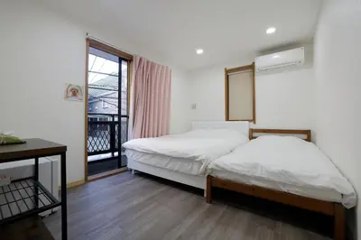a bedroom with a bed and a window at Tokyo My Home 201 in Tokyo