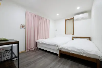 a small bedroom with a bed and a window at Tokyo My Home 201 in Tokyo