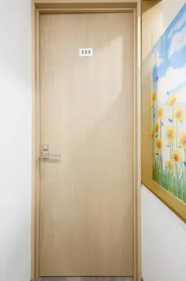 a door with a sign on it next to a painting at 3 min from Shin-Okubo l Private Single Room in Tokyo