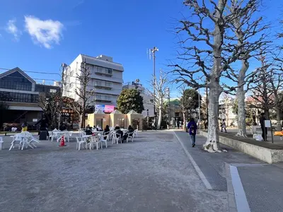 a street with tables and chairs in a city at 3 min from Shin-Okubo l Private Family Room for 5 in Tokyo