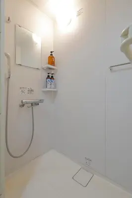 a bathroom with a shower and a mirror at 3 min from Shin-Okubo l Family Room for 4 in Tokyo