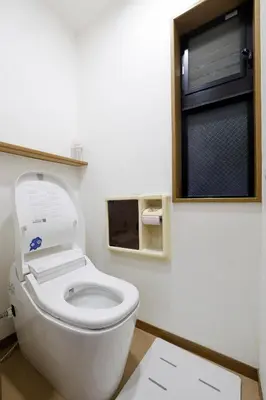 a bathroom with a white toilet with a window at 3 min from Shin-Okubo l Family Room for 4 in Tokyo