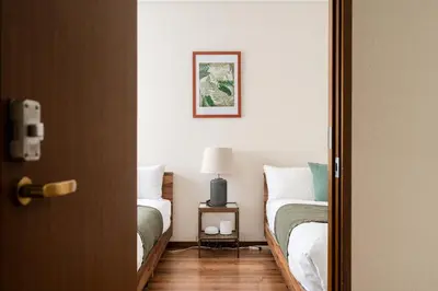 a room with two beds and a lamp on a table at HOTEL AndPlace ShinOkubo in Tokyo