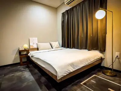a bedroom with a bed and a window with curtains at Mando Hotel 101 ,direct to Ueno,Asakusa in Tokyo