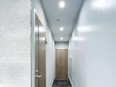 a hallway with a door in a room with white walls at Mando Hotel 101 ,direct to Ueno,Asakusa in Tokyo