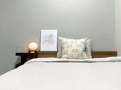 a bedroom with a white bed with a pillow and a picture at Mando Hotel 101 ,direct to Ueno,Asakusa in Tokyo