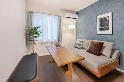 a living room with a couch and a table at Suzume sky house in Tokyo