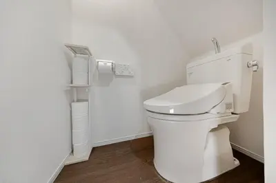 a white bathroom with a toilet and a phone at Suzume sky house in Tokyo