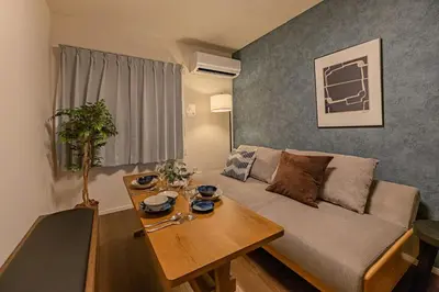 a living room with a couch and a table at Suzume sky house in Tokyo