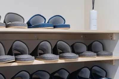 a row of shoes sitting on a shelf at Suzume sky house in Tokyo