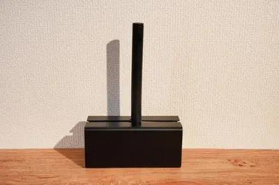 a black object with a shadow of a building at R-Styles \u6e0b\u8c37 in Tokyo