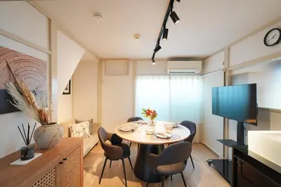 a dining room with a table and chairs in a room at R-Styles \u6e0b\u8c37 in Tokyo