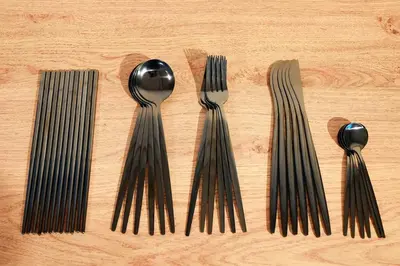 a group of forks and spoons on a wooden table at R-Styles \u6e0b\u8c37 in Tokyo