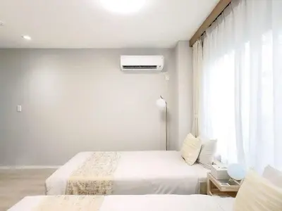 a bedroom with two beds and a window at Mando Hotel 201 ,direct to Ueno,Asakusa in Tokyo
