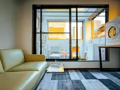 a living room with a couch and a large window at Mando Hotel 201 ,direct to Ueno,Asakusa in Tokyo