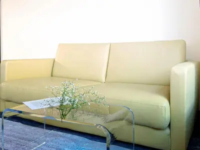 a couch with a coffee table with a plant on it at Mando Hotel 201 ,direct to Ueno,Asakusa in Tokyo