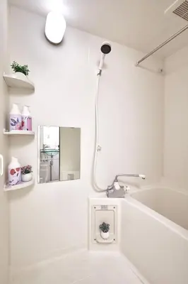 a white bathroom with a shower and a bath tub at 3-min walk to bus stop, direct to Shibuya Shinjuku in Tokyo
