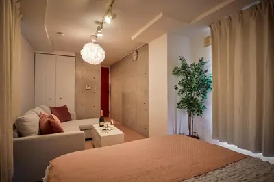 a bedroom with a bed and a couch and a living room at 3-min walk to bus stop, direct to Shibuya Shinjuku in Tokyo