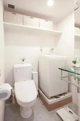 a white bathroom with a toilet and a sink at 3-min walk to bus stop, direct to Shibuya Shinjuku in Tokyo