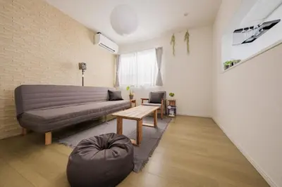 a living room with a couch and a table at Tokyo Kanamachi Inn in Tokyo